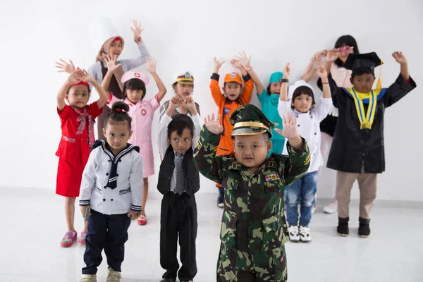 Niños vestidos con trajes de diferentes profesiones —  Fotos de Stock