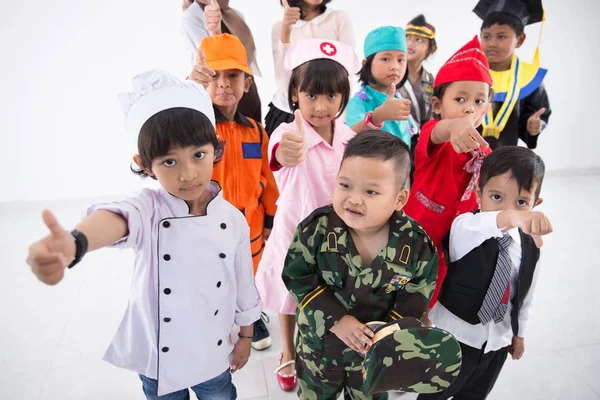 Crianças com uniforme multi profissão diversificada — Fotografia de Stock