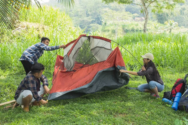 tourist help each other prepare tent