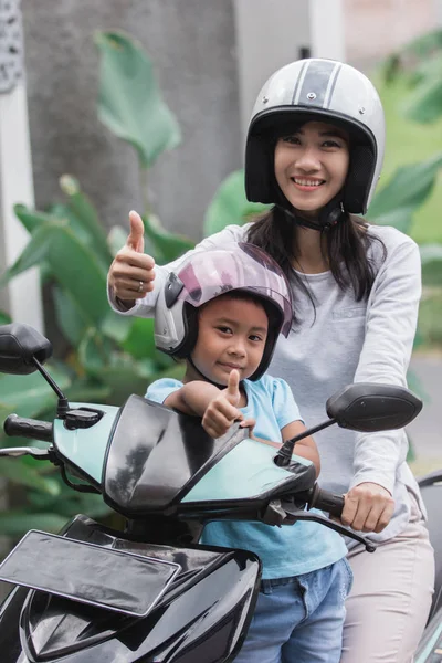 Mother and daughter riding motorbike scooter — Stock Photo, Image