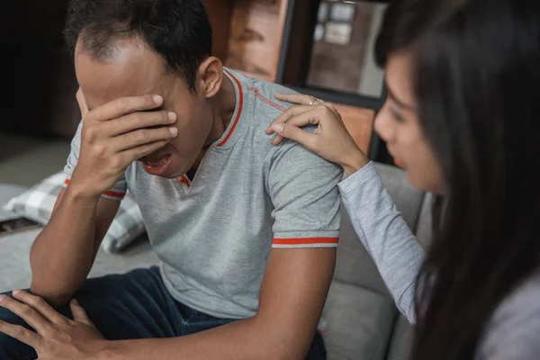 woman comforting her sad mourning man