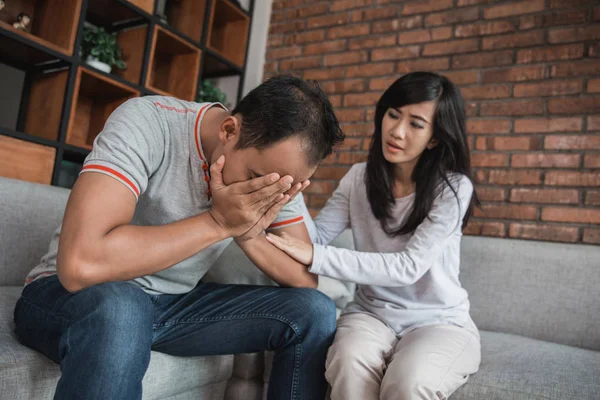 woman comforting her sad mourning man