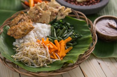nasi pecel. vegetable with peanut sauce clipart