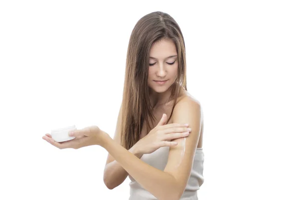 Beautiful girl applying body lotion on her body — Stock Photo, Image