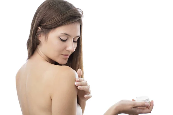 Beautiful girl applying body lotion on her body — Stock Photo, Image