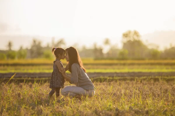 Mãe e filha beijando no campo — Fotografia de Stock