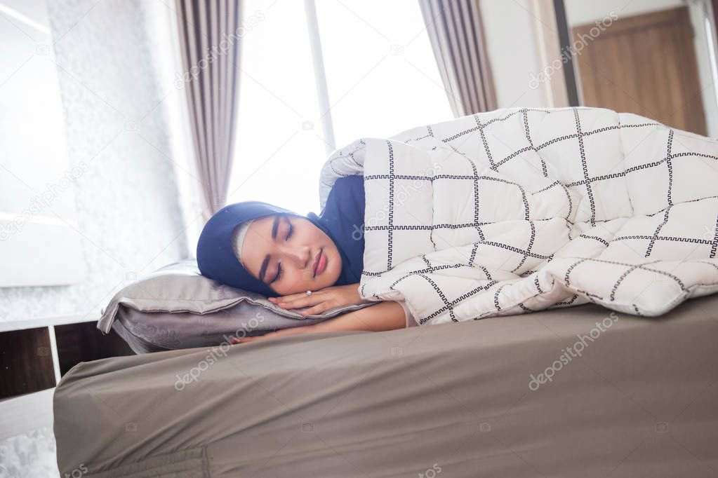 sleeping muslim woman in bed