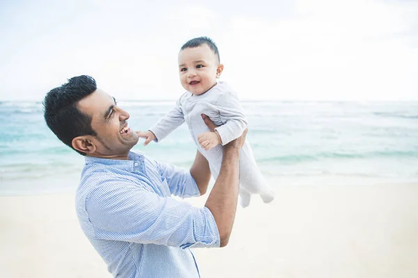 Pohledný tatínek hraje s jeho roztomilý synem na pláži — Stock fotografie