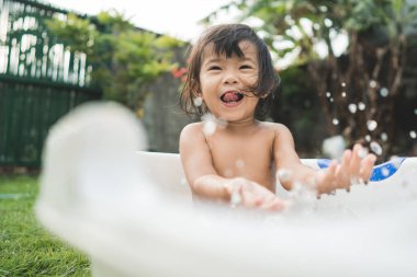 mutlu güzel kız bebek bebek küvet içinde bir banyo almak
