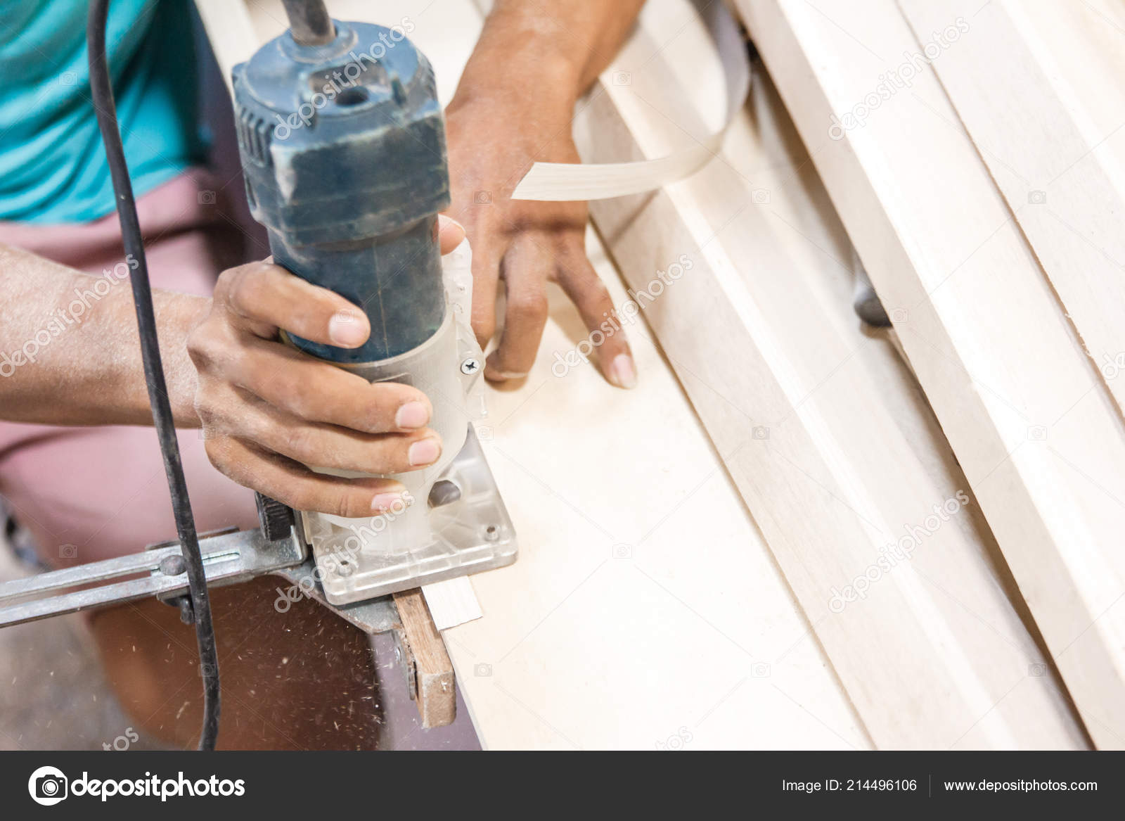 Workers hands cutting the edge of wood board using fret saw Stock Photo