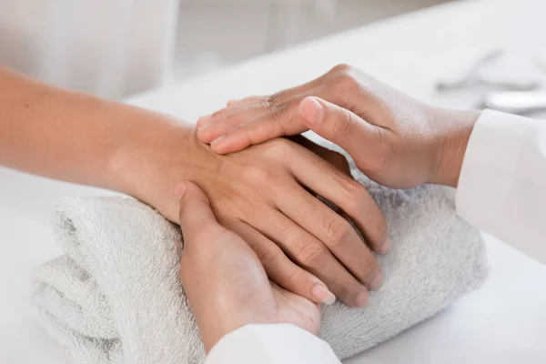 Jovem está recebendo uma massagem de mão com esteticista — Fotografia de Stock