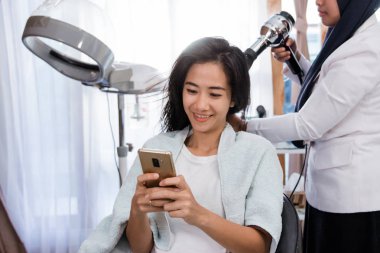 tedavi elde ederken cep telefonu kullanan kadın