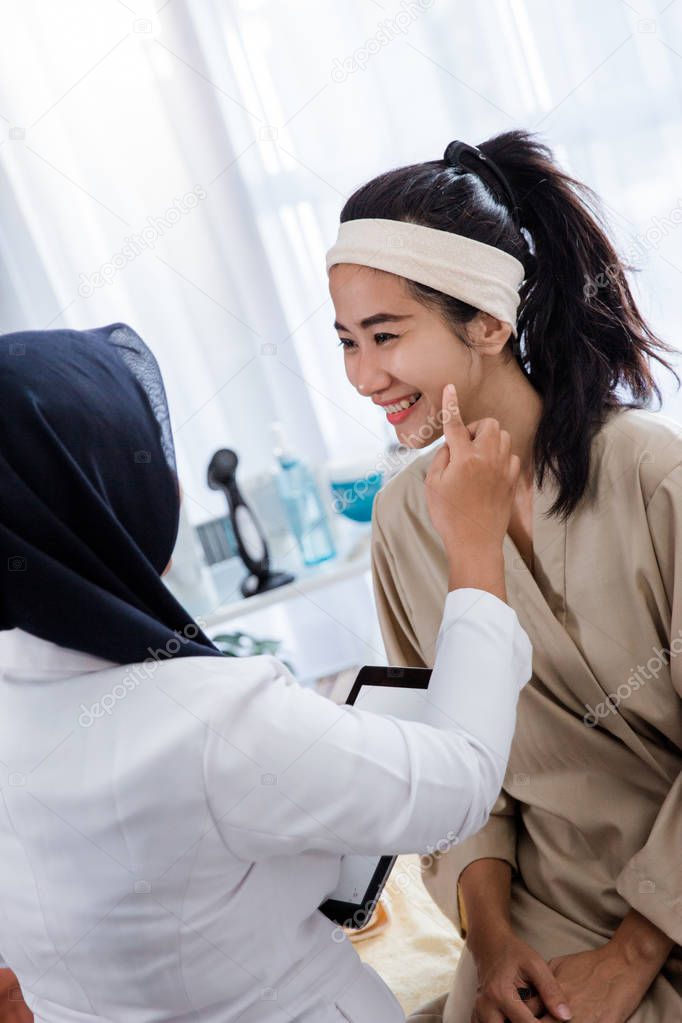 Woman face being checked by beauticians