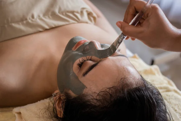 Woman in spa salon getting face mask by beautician — Stock Photo, Image