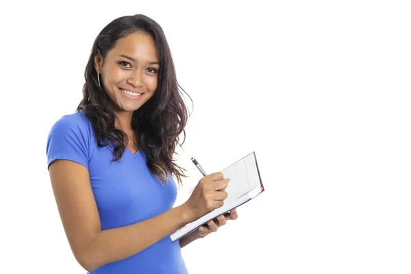 Casual college student schrijven op een notitieblok staand en — Stockfoto