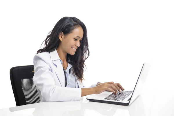 Asiatico giovani medico sorridente e lavorando su il suo computer portatile — Foto Stock
