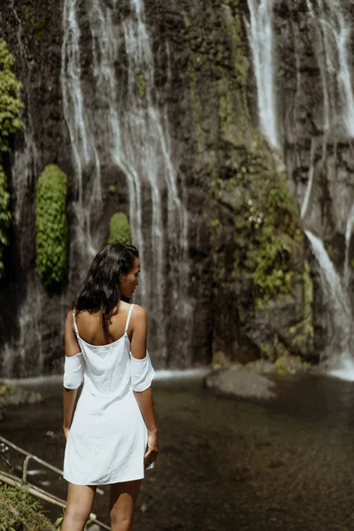 Stylish young woman taking picture for social media in waterfall — Stock Photo, Image