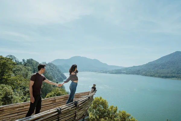 Pareja cogida de la mano disfrutando de la naturaleza desde la cima —  Fotos de Stock