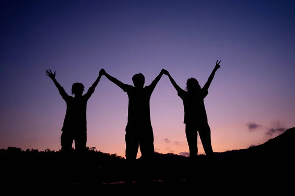 Silhouette of camping group hands up together — Stock Photo, Image