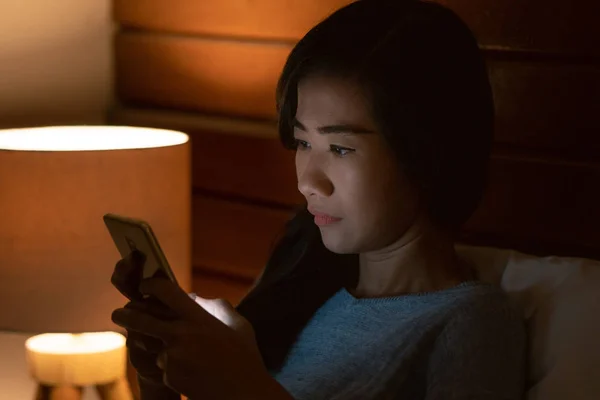 woman browsing online before sleeping at home