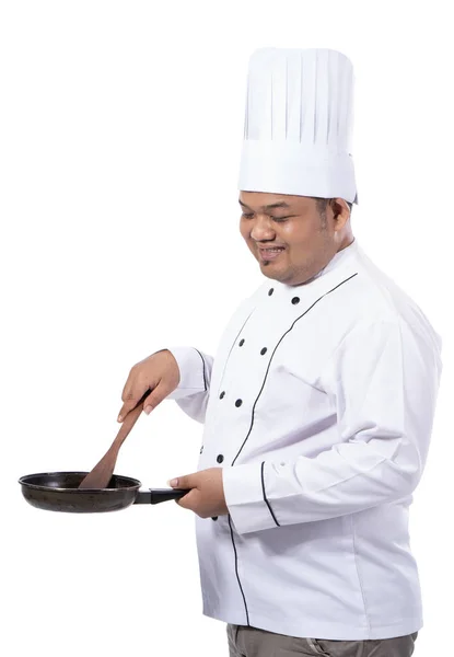 Beelden van chef-kok koken naast weergeven met een bedrijf van pan en spatel — Stockfoto