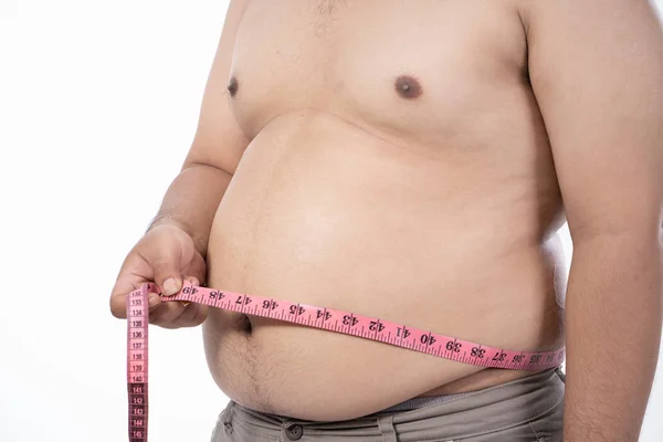 Close up of naked young man measurement his stomach Stock Image