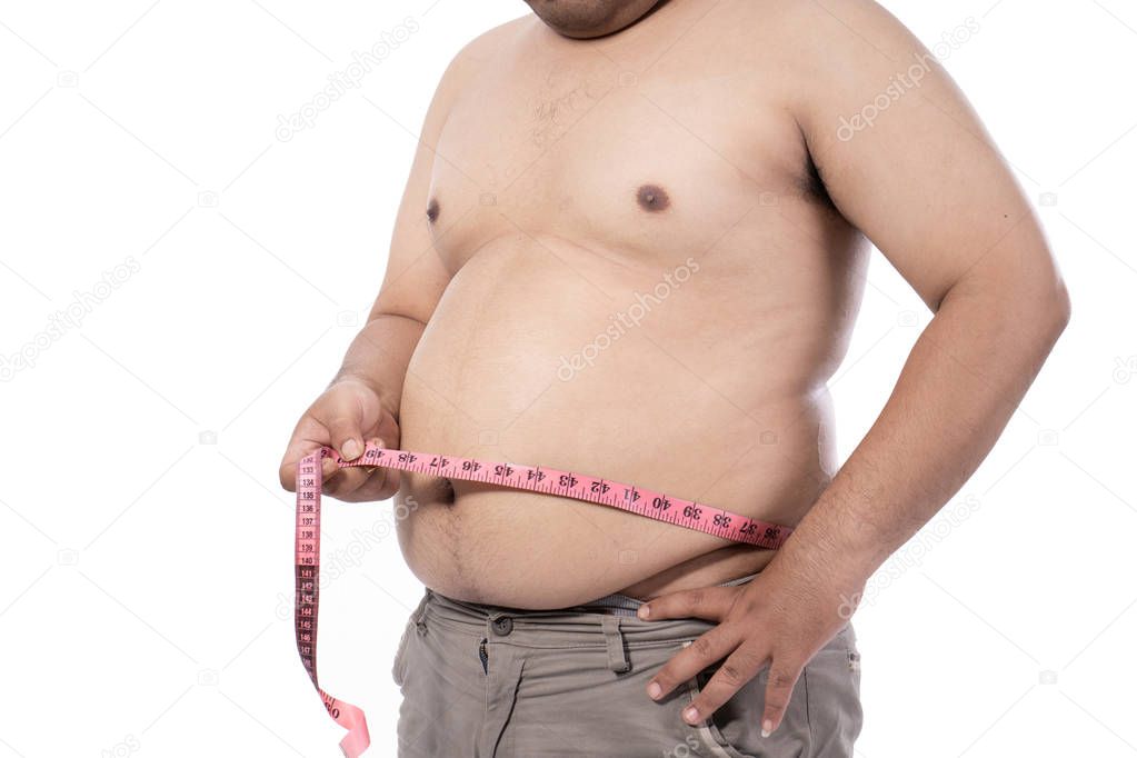 portrait of naked young man measurement his stomach