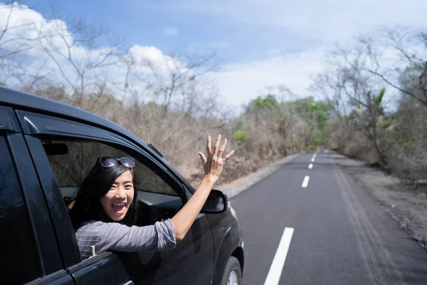 Woman enjoying her trip going on vacation by car — Stock Photo, Image