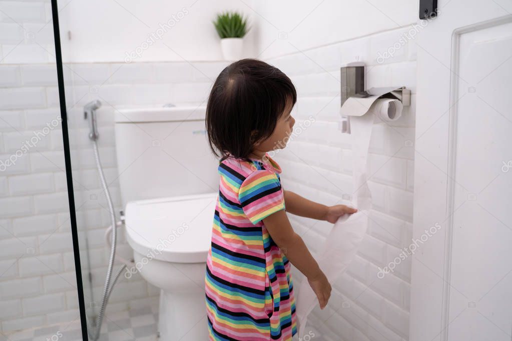 toddler pulling out toilet paper 