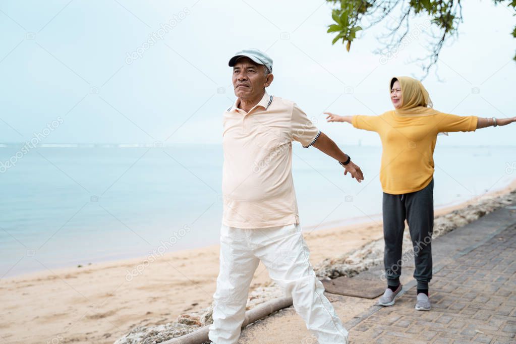 muslim senior couple doing stretching and exercising outdoor 