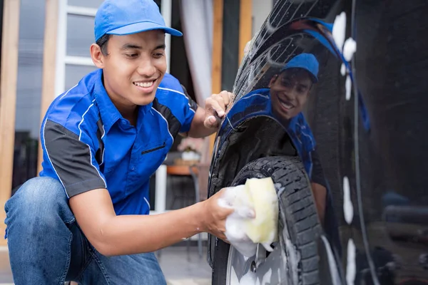 Άνδρας με στολή καθαρισμού του αυτοκινήτου τους πελάτες — Φωτογραφία Αρχείου