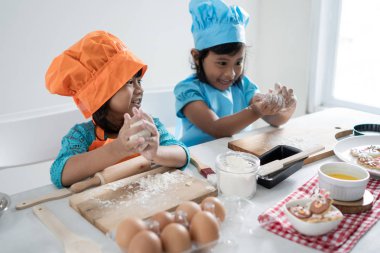 kids make some dough and cookies together clipart