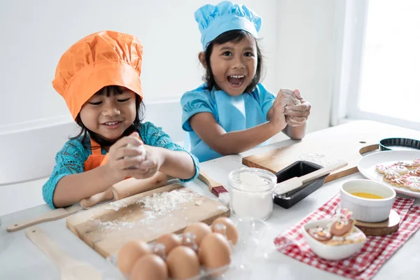 two girls toddler learn cooking and make some dough