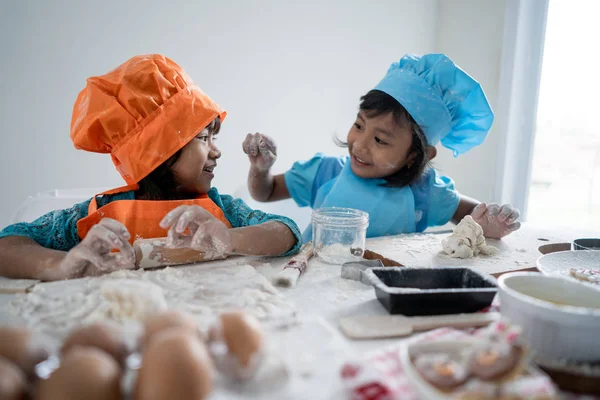 two girls toddler learn cooking and make some dough