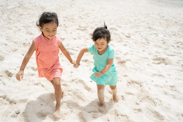 Two little girl running with hold hand enjoy playing together — Stock Photo, Image