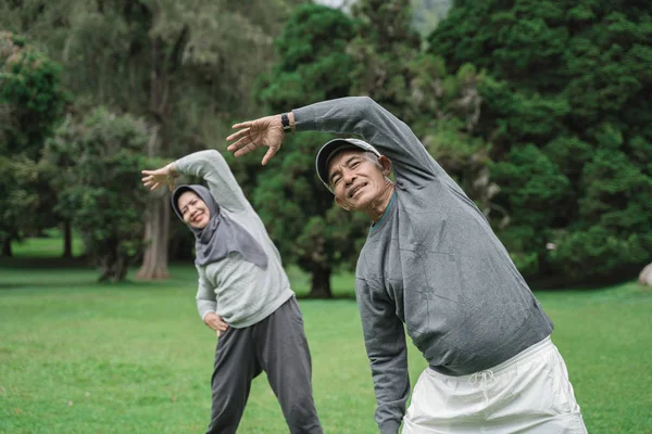 Dos hombres y mujeres mayores haciendo algunos estiramientos — Foto de Stock