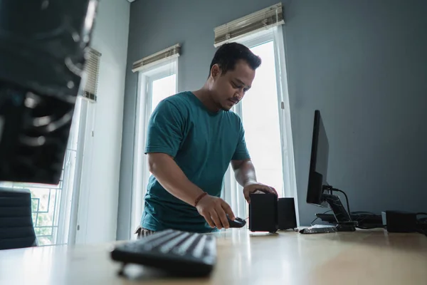 portrait of asian young man fix a problem of personal computer