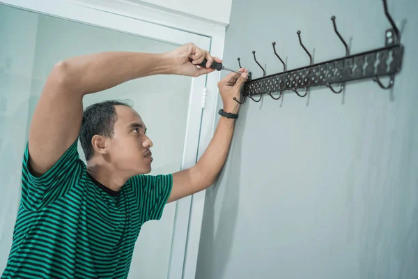 portrait of asian young man work with screwdriver