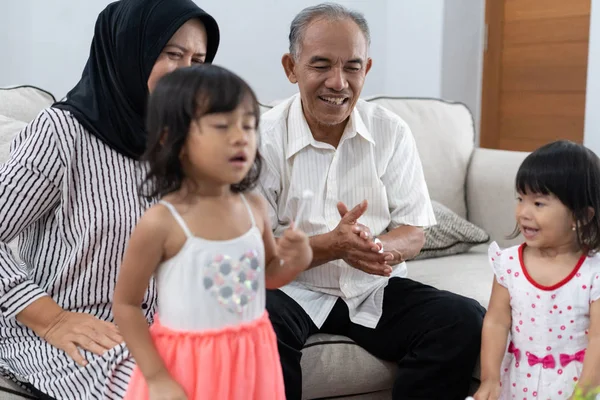 Opa geluk door zijn handen klappen tijdens het spelen met twee kleinkinderen — Stockfoto