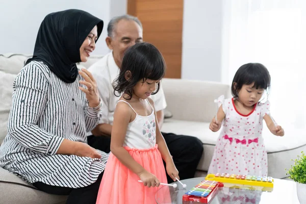 Grandparent with their granddaughters playing together — Stock Photo, Image