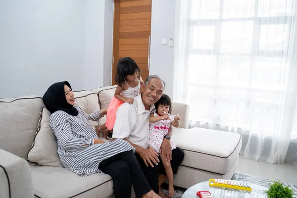 自分の孫を自宅で幸せなアジアのイスラム教徒祖父母 — ストック写真