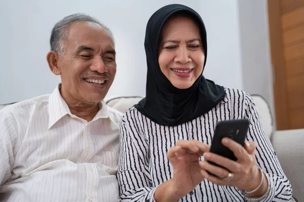 senior couple using mobile phone