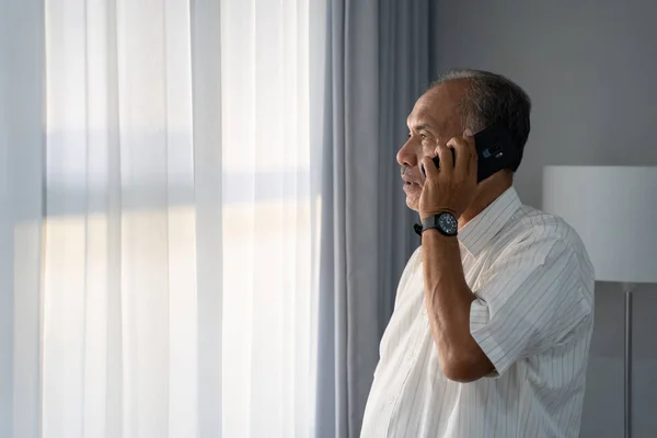 senior asian man calling with smartphone