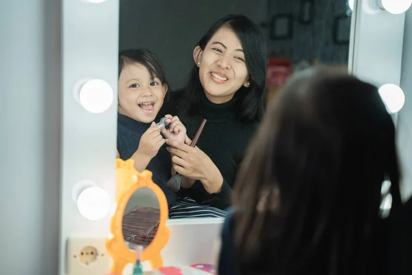 Hija feliz cara maquillaje con mamá —  Fotos de Stock