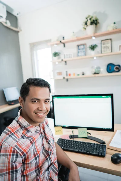 asian man worker sitting front of monitor computer