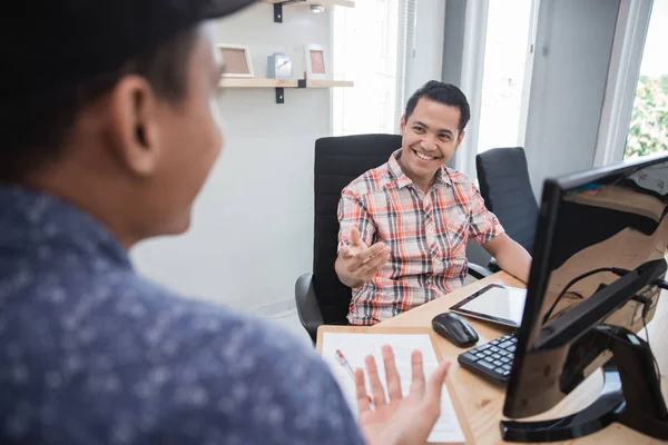 creative business deal shaking hand in the office