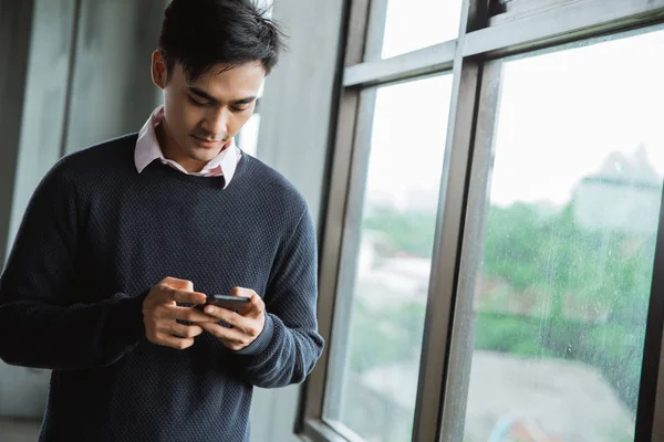 Bild eines jungen asiatischen Mannes mit Smartphone — Stockfoto