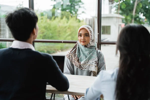 veiled women interviewed as new employees by two human resources departments