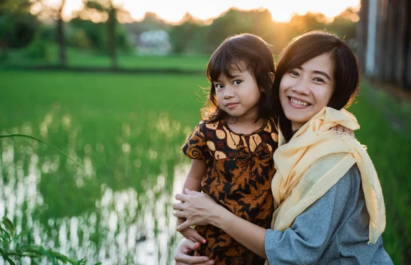 Musulmán asiático mujer al aire libre con su hija —  Fotos de Stock