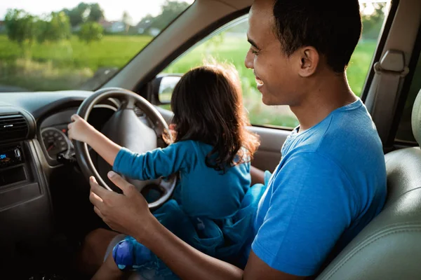 Kid playing with steering wheel dad — Stock Photo, Image